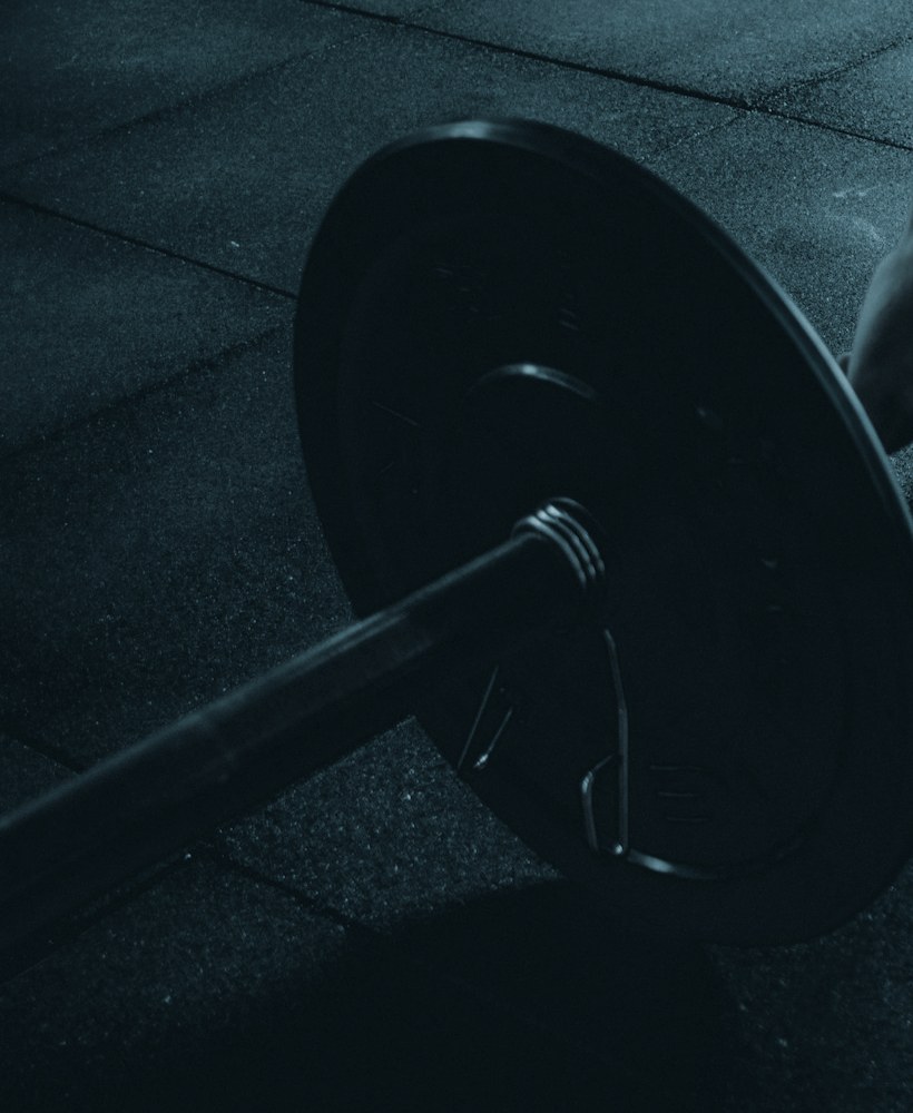 Loaded barbell resting on a gym floor